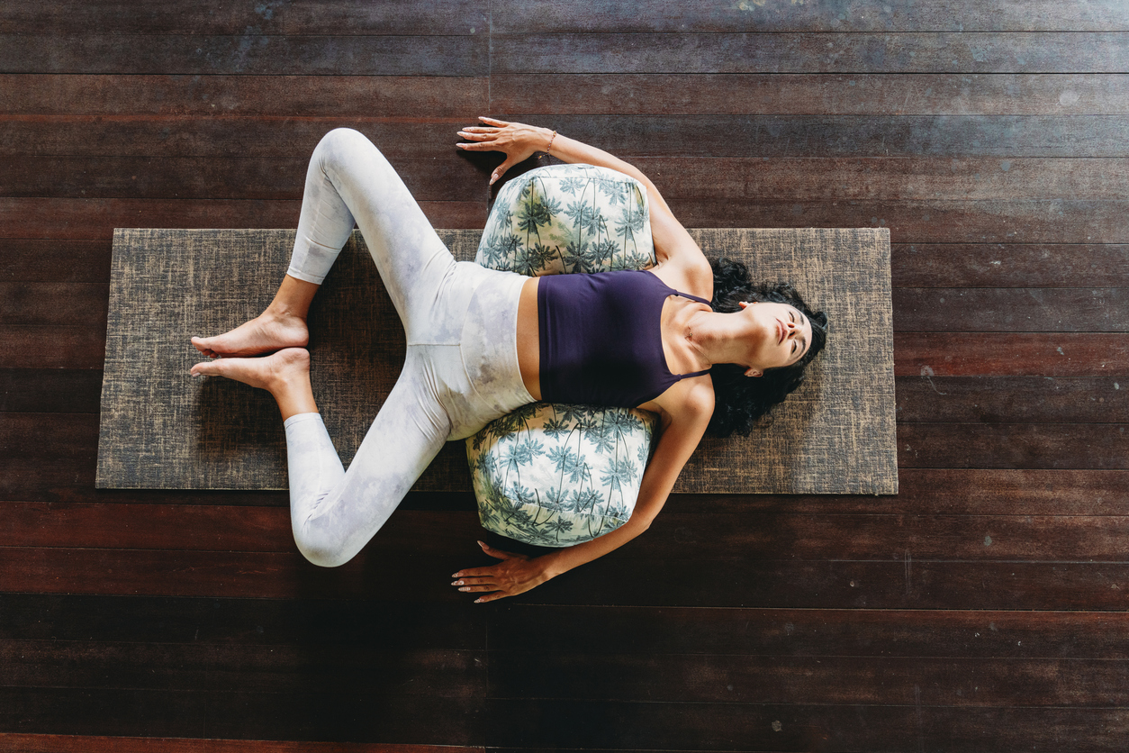 Constructive rest position with bolster under hips for passive psoas release — home care after myofascial release session